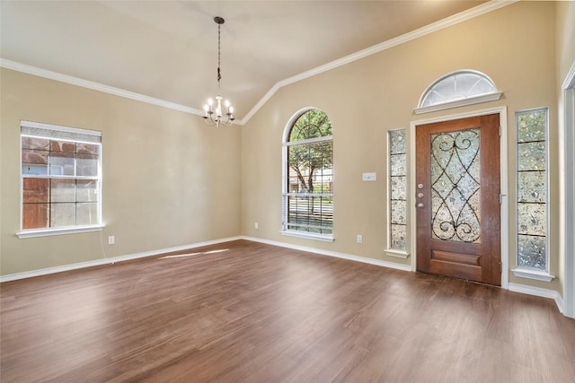 entrance foyer with crown molding, baseboards, a chandelier, dark wood finished floors, and lofted ceiling