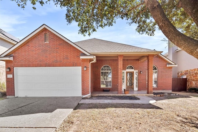 ranch-style home featuring fence, driveway, a shingled roof, a garage, and brick siding