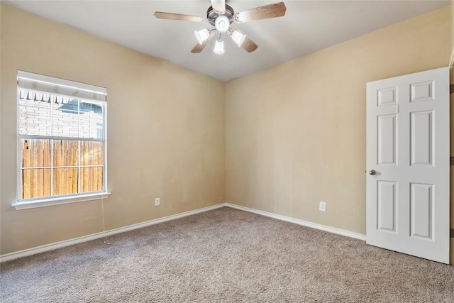 unfurnished room featuring baseboards, ceiling fan, and carpet floors