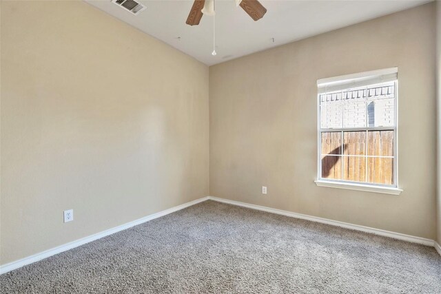 unfurnished room featuring baseboards, visible vents, carpet floors, and ceiling fan