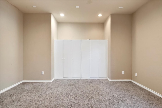 unfurnished bedroom with recessed lighting, baseboards, and carpet