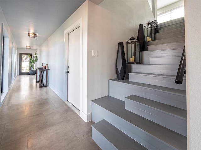 stairs featuring tile patterned flooring