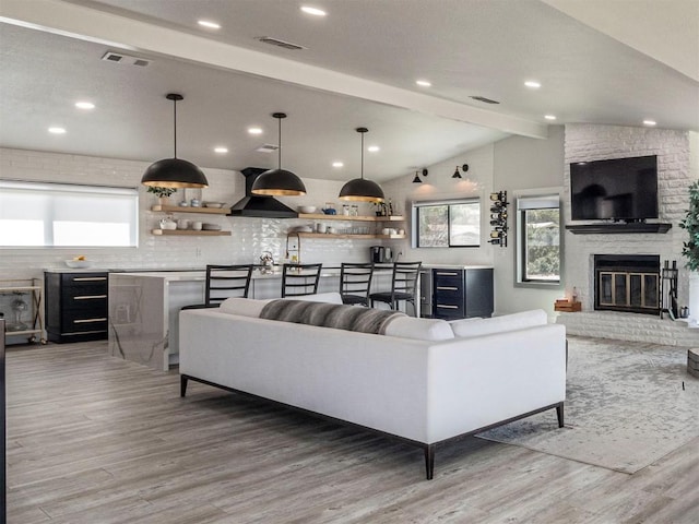 living room featuring wood finished floors, a fireplace, and recessed lighting
