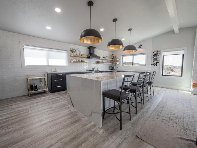 kitchen with wall chimney range hood, open shelves, light wood-style flooring, plenty of natural light, and recessed lighting