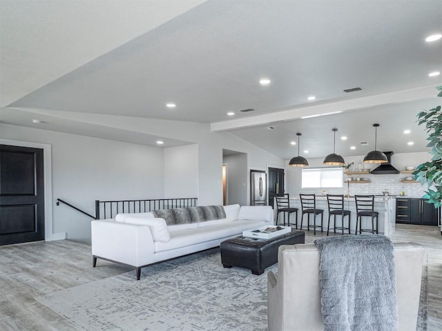 living area with light wood-style flooring and recessed lighting