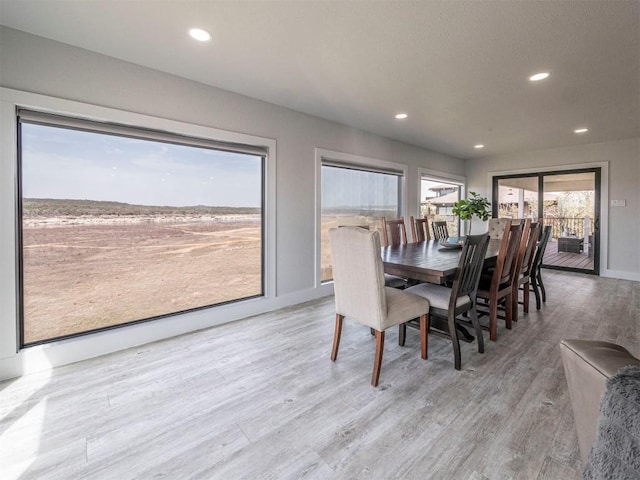 dining room with light wood finished floors, recessed lighting, and baseboards