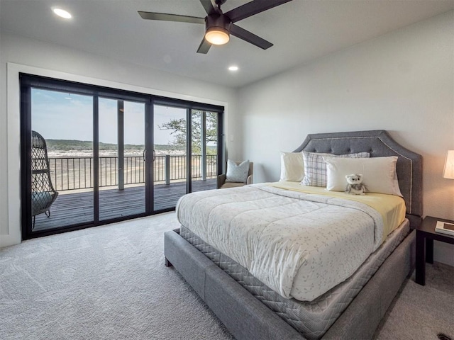 carpeted bedroom featuring access to outside, recessed lighting, a water view, and ceiling fan