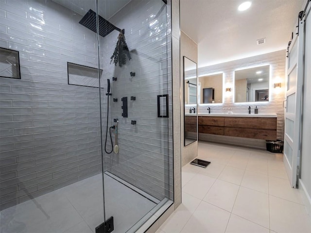 bathroom with a stall shower, tile patterned floors, double vanity, and recessed lighting