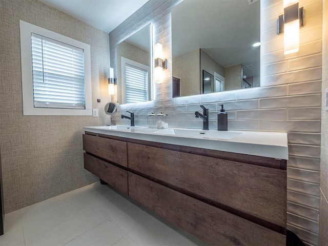 full bathroom featuring double vanity, tile patterned floors, and backsplash