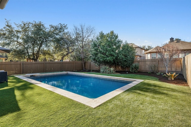 view of swimming pool with a fenced backyard, a fenced in pool, and a yard