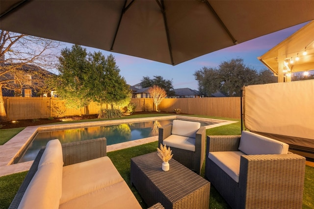 view of patio / terrace featuring an outdoor living space, a fenced backyard, and a fenced in pool