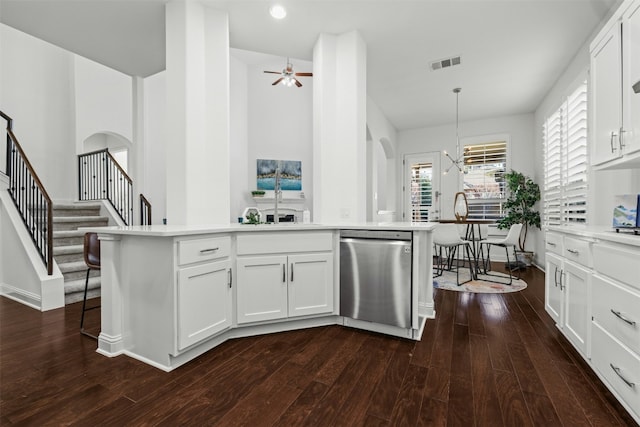 kitchen with stainless steel dishwasher, light countertops, visible vents, and white cabinetry