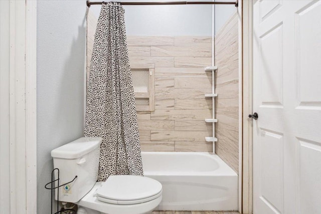 bathroom featuring toilet and shower / bath combo