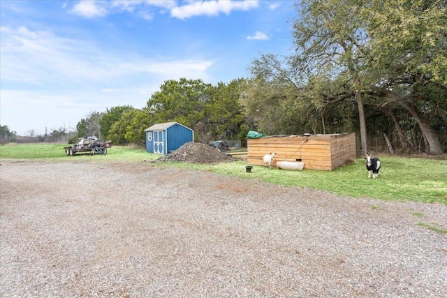 view of yard with an outbuilding and a storage shed