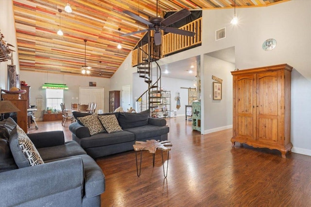 living room with high vaulted ceiling, a ceiling fan, wood finished floors, and stairs