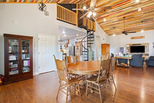 dining room featuring visible vents, high vaulted ceiling, a ceiling fan, wood finished floors, and stairway