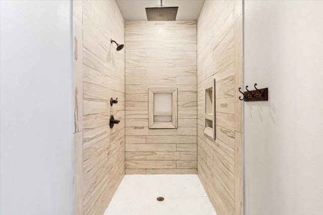 full bath with a tile shower