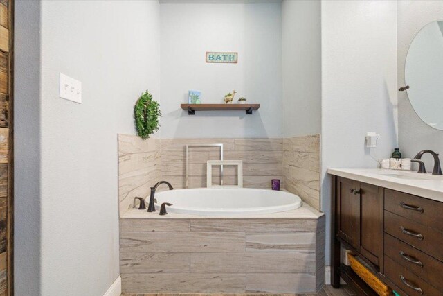 bathroom with a bath and vanity