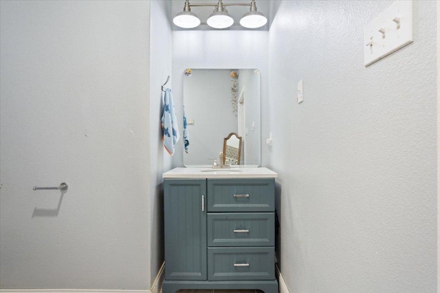 bathroom with vanity and baseboards