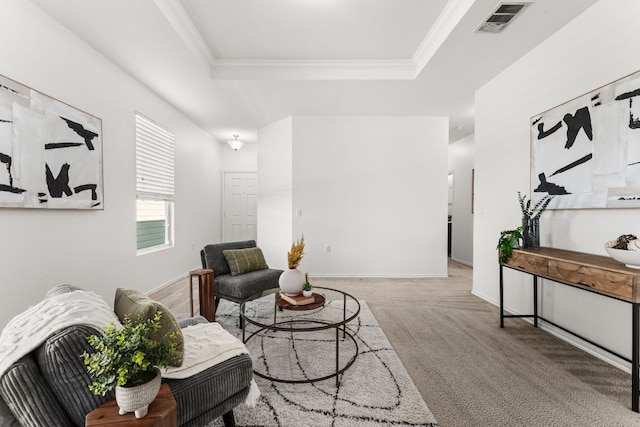 living area with a raised ceiling, carpet flooring, crown molding, and visible vents