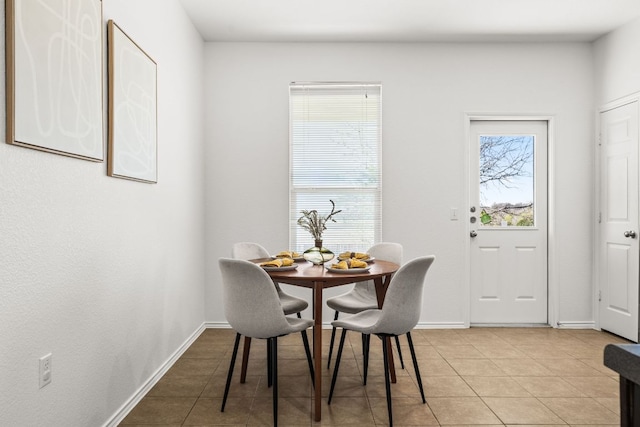 dining space with light tile patterned floors and baseboards