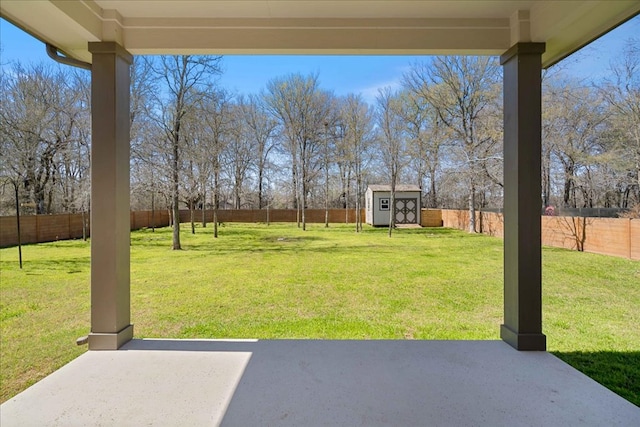 view of yard with a fenced backyard, a patio, a storage shed, and an outdoor structure