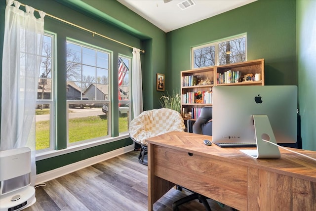 office with visible vents, baseboards, and wood finished floors