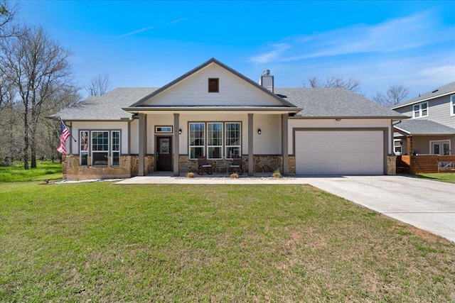 view of front of property featuring a front lawn, a chimney, a garage, stone siding, and driveway