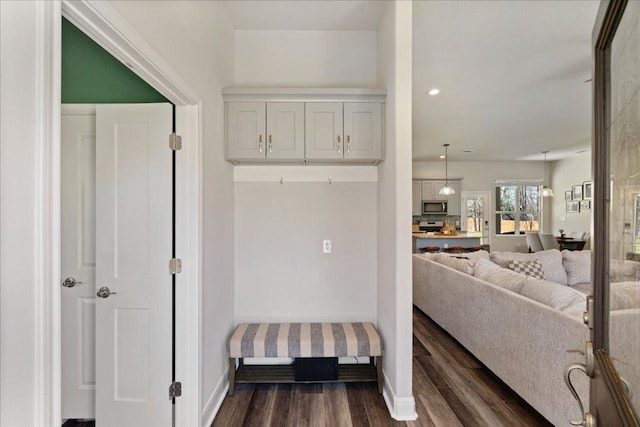 interior space featuring recessed lighting, dark wood-style flooring, and baseboards