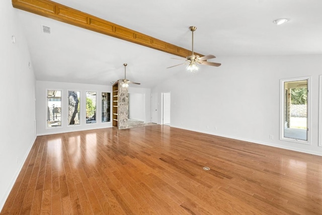 unfurnished living room with plenty of natural light, a ceiling fan, light wood-type flooring, and visible vents