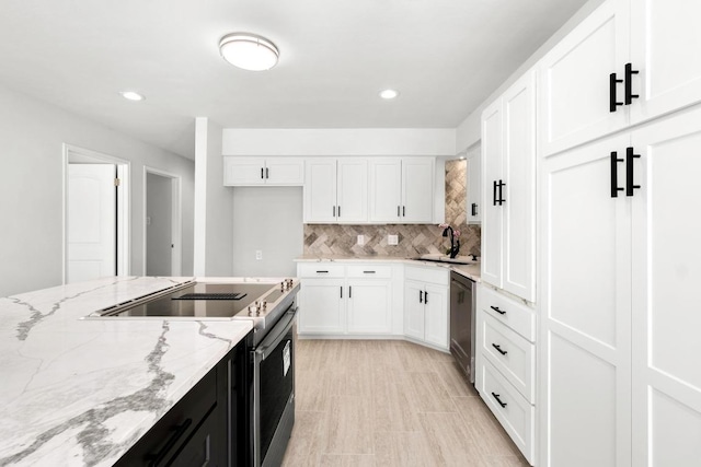 kitchen with stainless steel appliances, tasteful backsplash, dark cabinetry, and white cabinetry