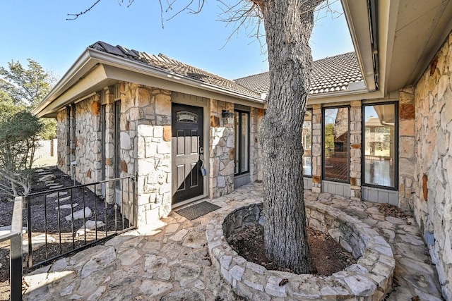 entrance to property with stone siding