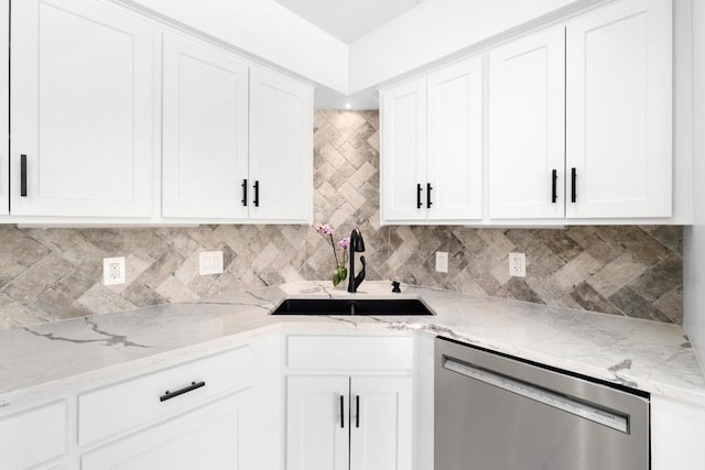 kitchen with dishwasher, decorative backsplash, white cabinetry, and a sink