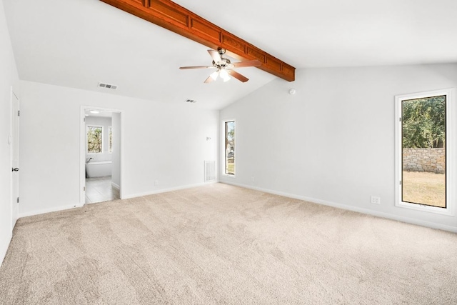 empty room with visible vents, lofted ceiling with beams, baseboards, and carpet floors