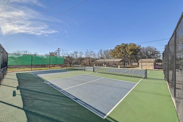 view of tennis court with fence