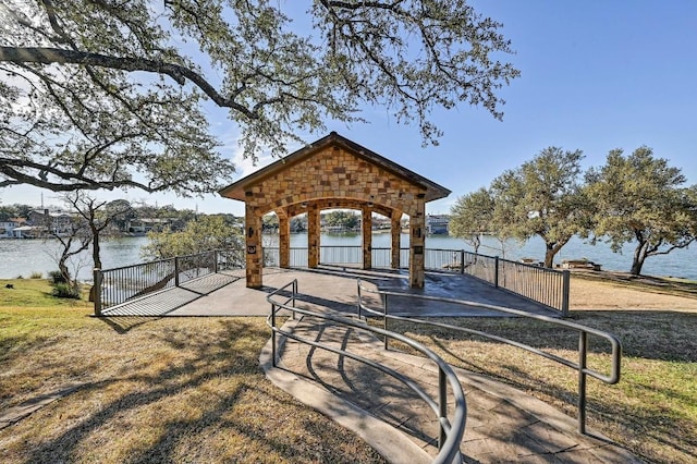 view of property's community with a gazebo and a water view