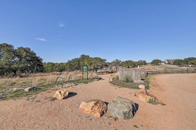 view of yard with a rural view and fence