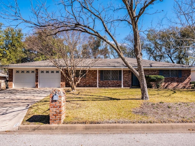 ranch-style house featuring a front lawn, an attached garage, brick siding, and concrete driveway