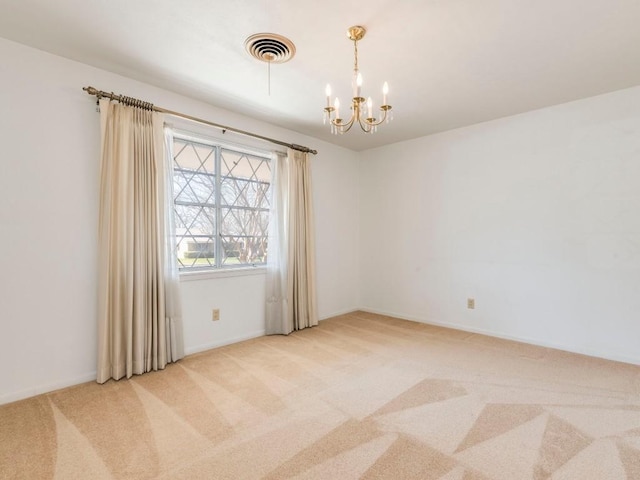 unfurnished room with visible vents, light carpet, a notable chandelier, and baseboards