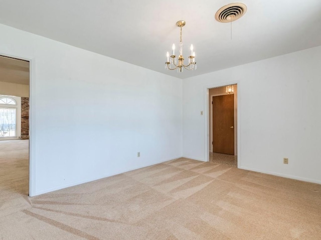 unfurnished room with visible vents, light colored carpet, and a notable chandelier