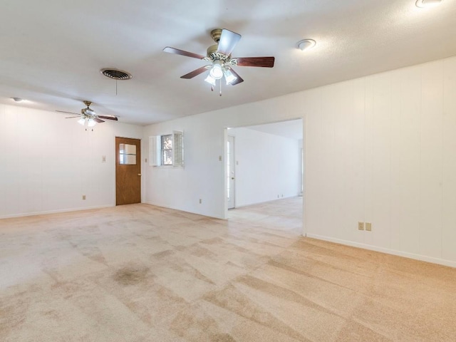 unfurnished room featuring visible vents, light colored carpet, and ceiling fan