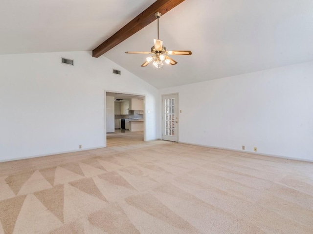 spare room with beamed ceiling, visible vents, and light carpet