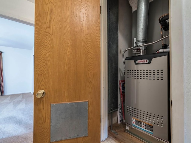 utility room featuring heating unit