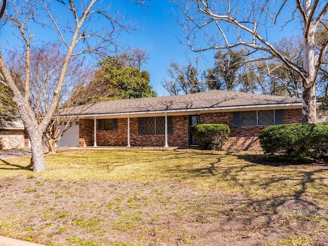 ranch-style house featuring brick siding, a front lawn, and a garage