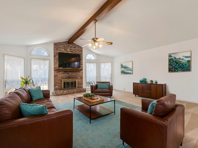 living area featuring lofted ceiling with beams, a ceiling fan, carpet, and a fireplace