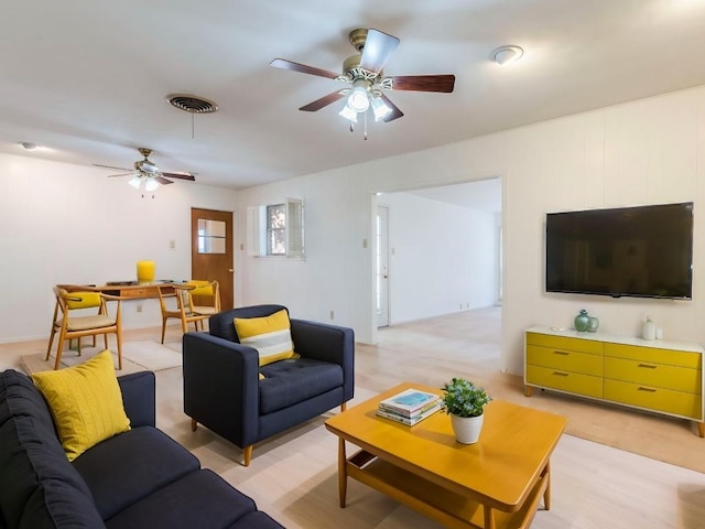 living room with visible vents and ceiling fan