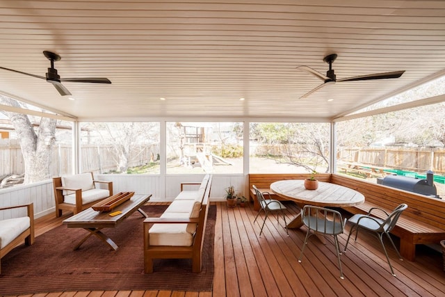 sunroom / solarium with a ceiling fan