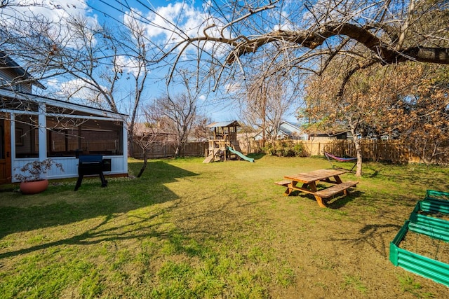 view of yard featuring a fenced backyard and a playground