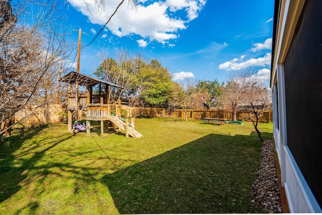 view of yard with a fenced backyard and a playground