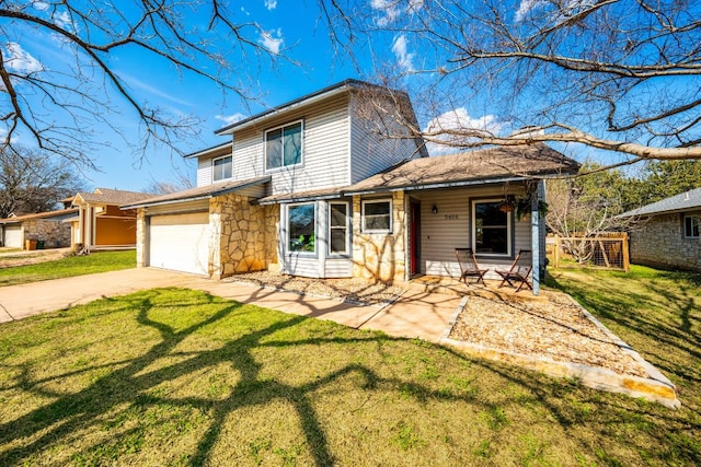 traditional home with stone siding, driveway, an attached garage, and a front lawn